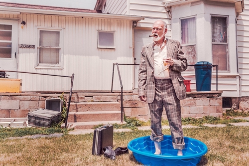 Business man standing in wading pool - represents lack of work - life balance