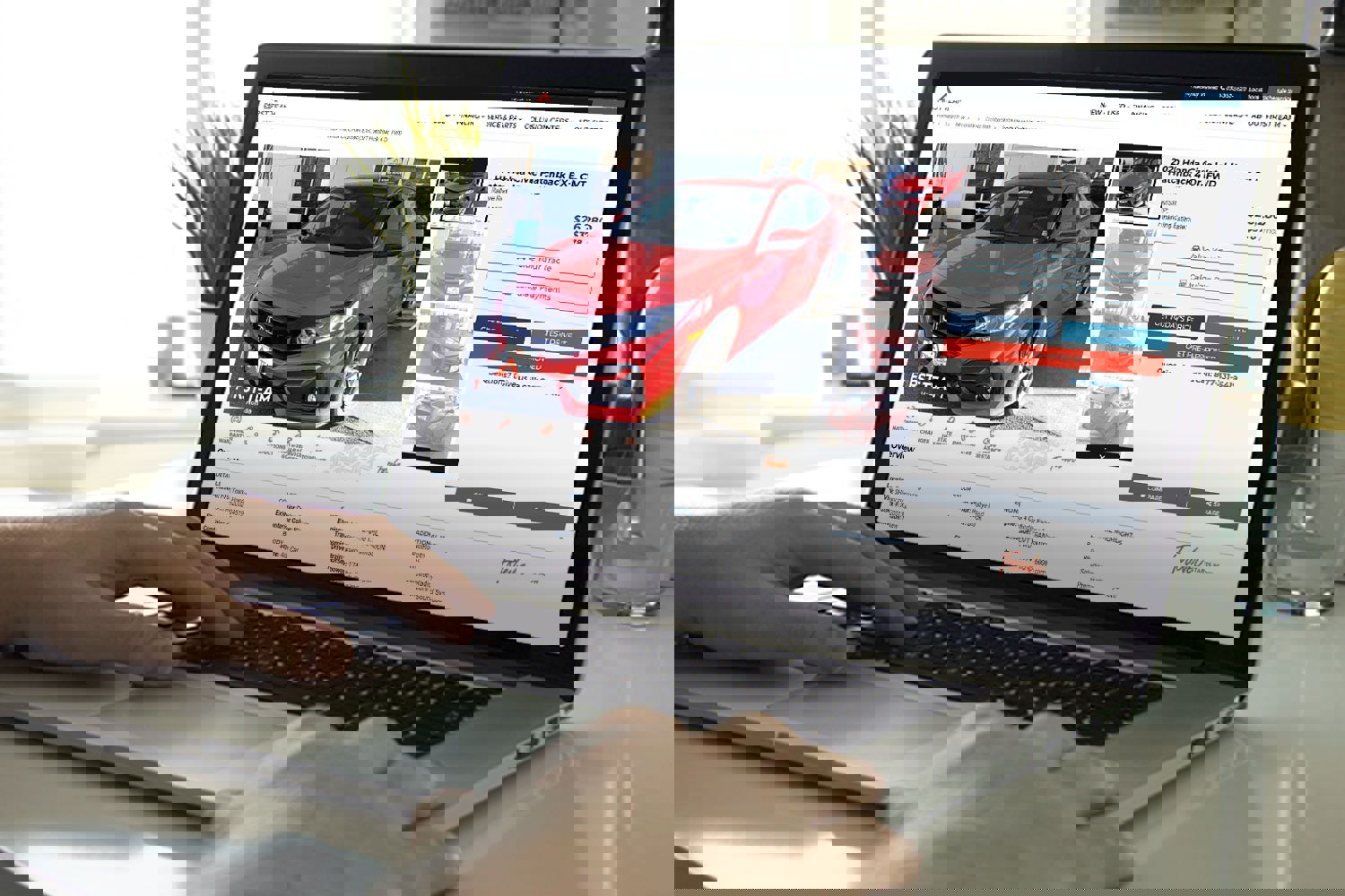 Man browsing cars on First Team Auto Group website